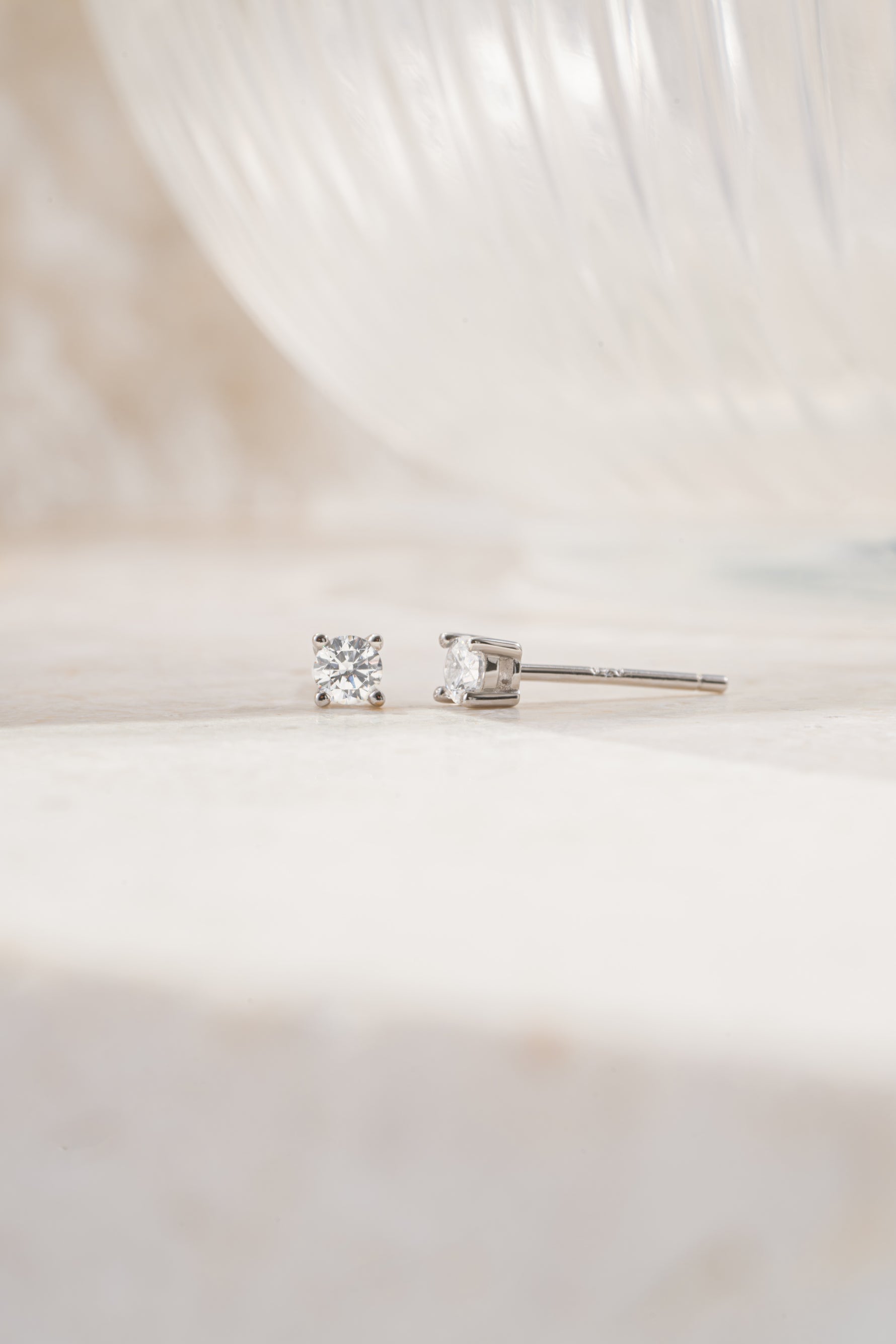 sterling silver 3mm diamond solitaire stud earrings side view white backhground