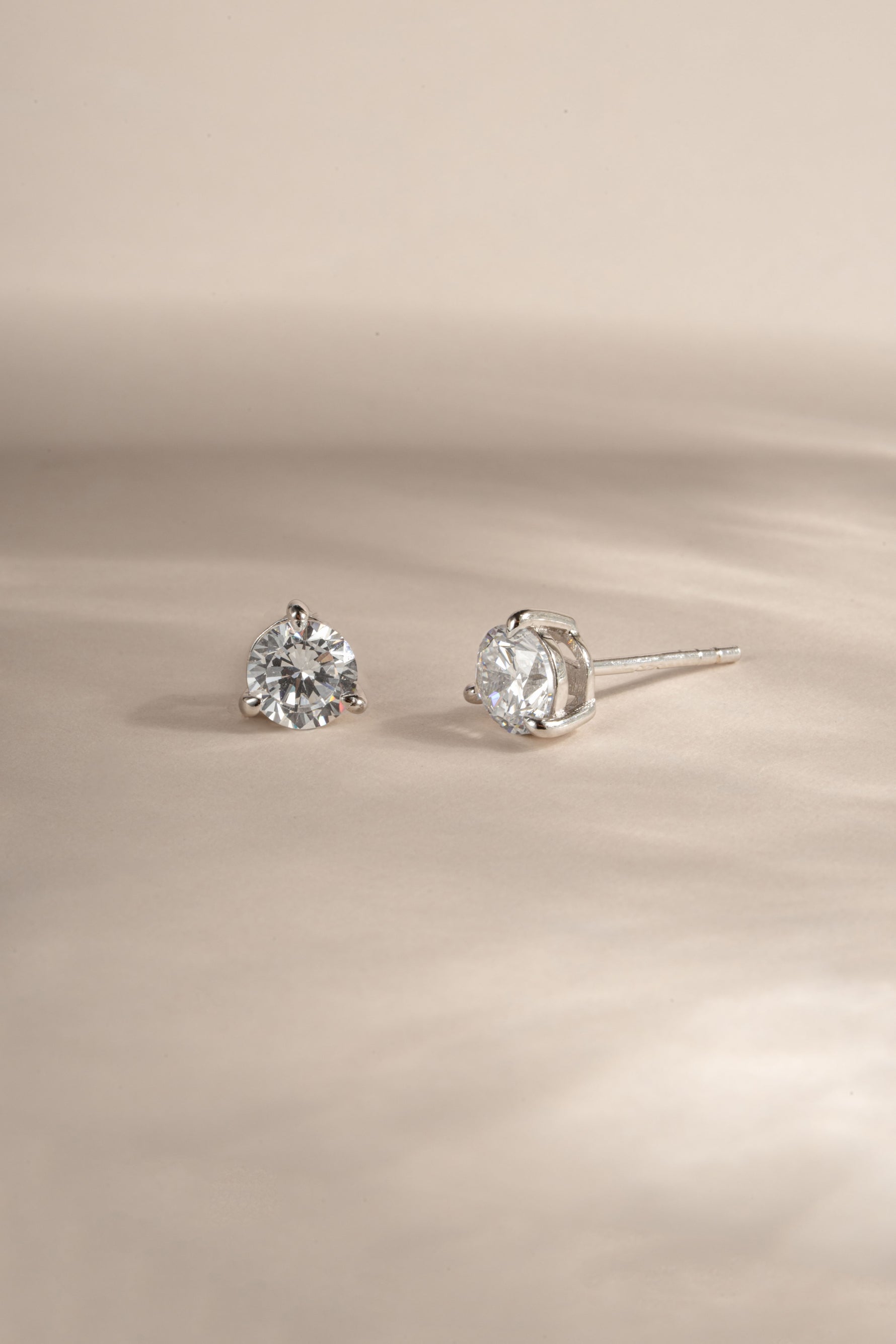 sterling silver diamond solitaire stud earrings neutral background 
