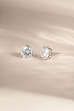Sterling silver 7.5mm round solitaire diamond stud earrings by Sami Jewels, showcasing shiny, classic jewelry design.