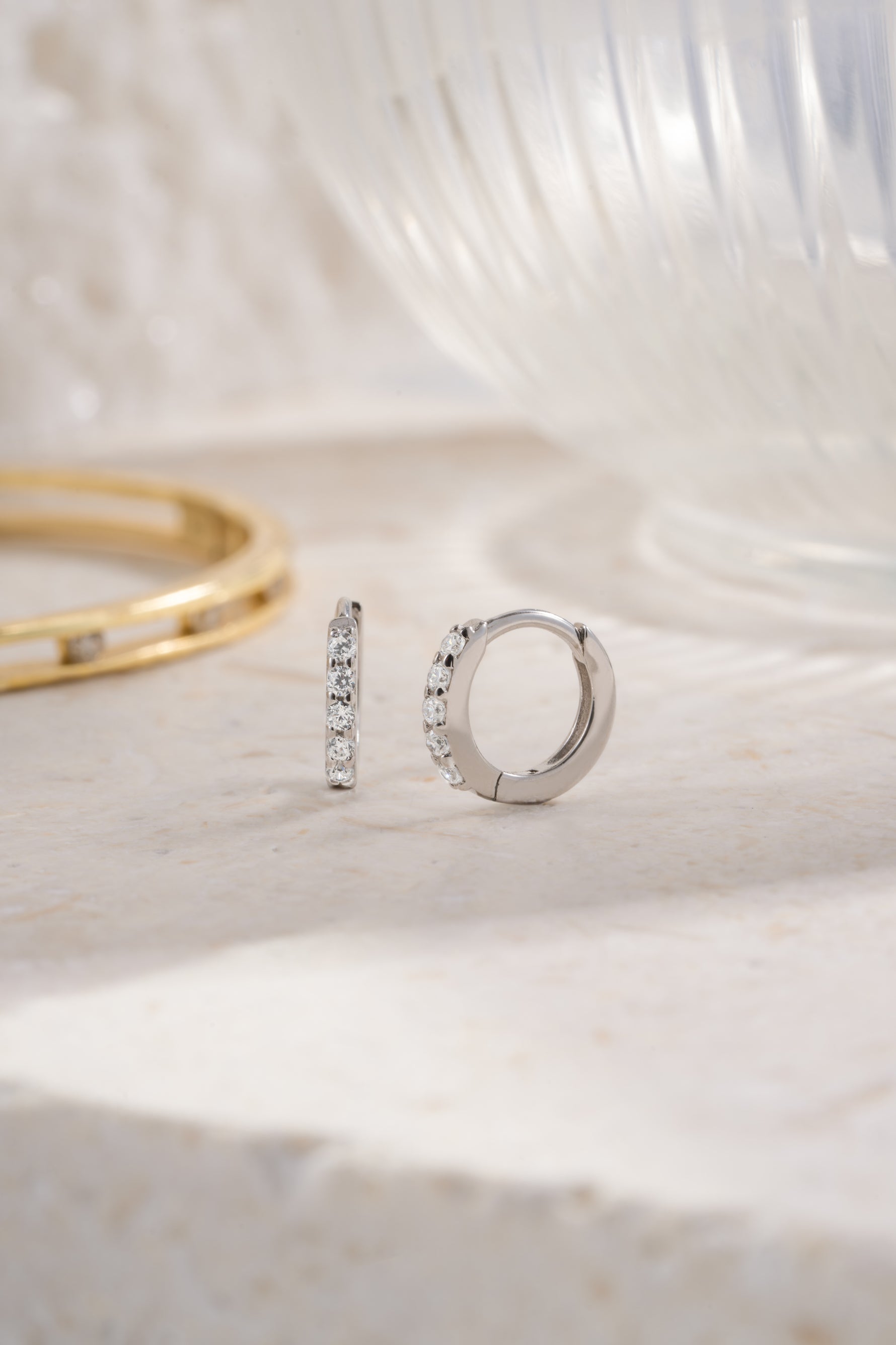 sterling silver 7mm diamond studded huggie plain background