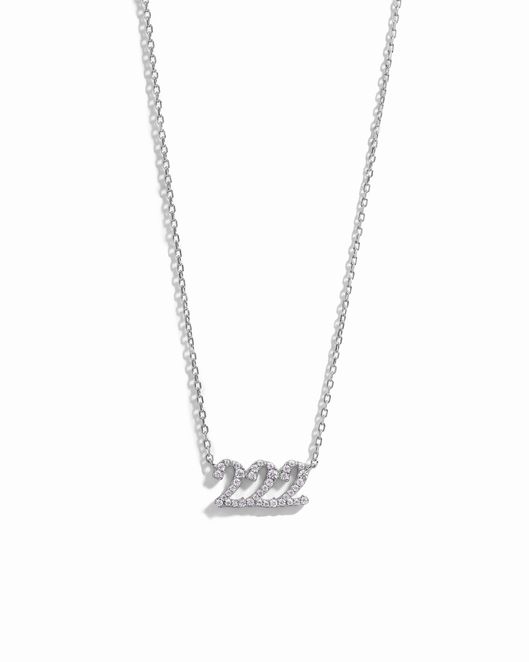 Silver necklace with 222 angel number pendant with tiny diamonds on a white background