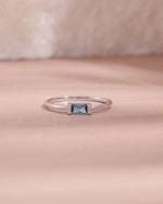 sterling silver aquamarine diamond baguette birthstone ring light pink background