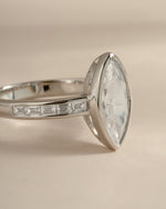 Sterling silver Bezel Marquise Ring with baguette CZ band showcasing intricate gemstone setting and elegant design.
