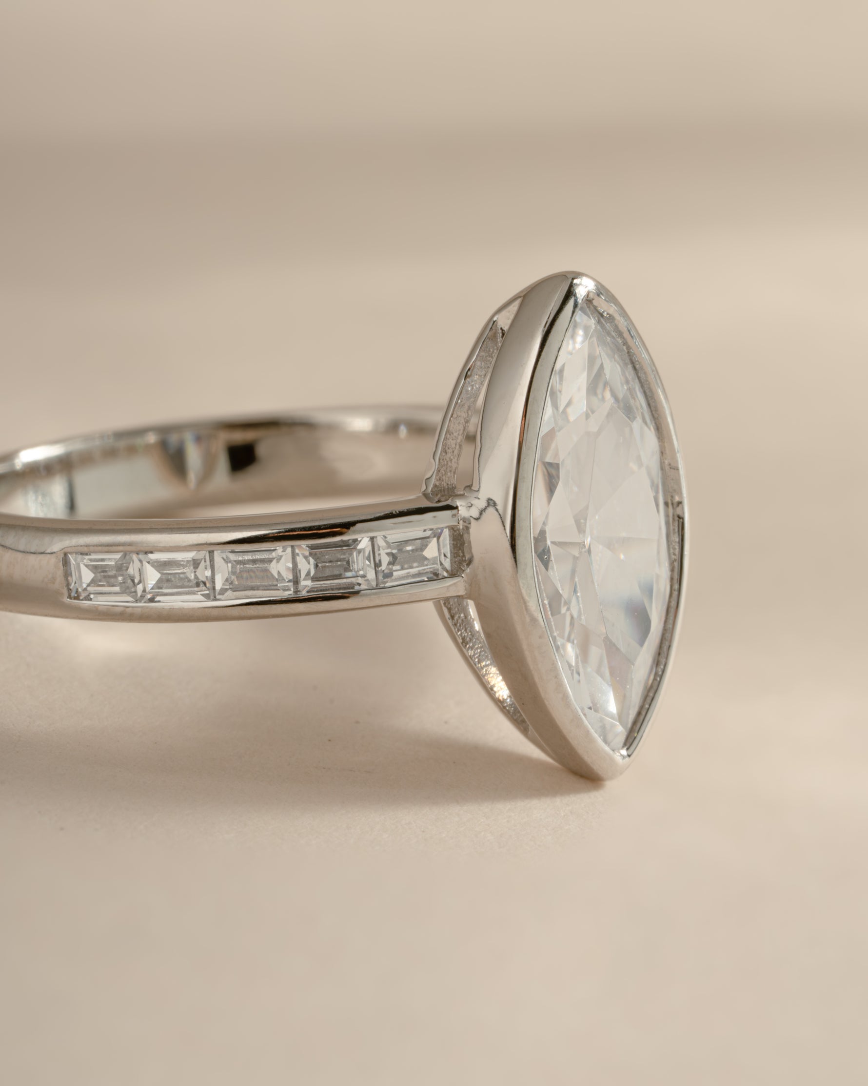 Sterling silver Bezel Marquise Ring with baguette CZ band showcasing intricate gemstone setting and elegant design.