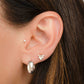 model wearing silver hoop earrings and dainty vintage earrings featuring a bee earring design