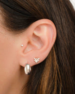 model wearing silver hoop earrings and dainty vintage earrings featuring a bee earring design