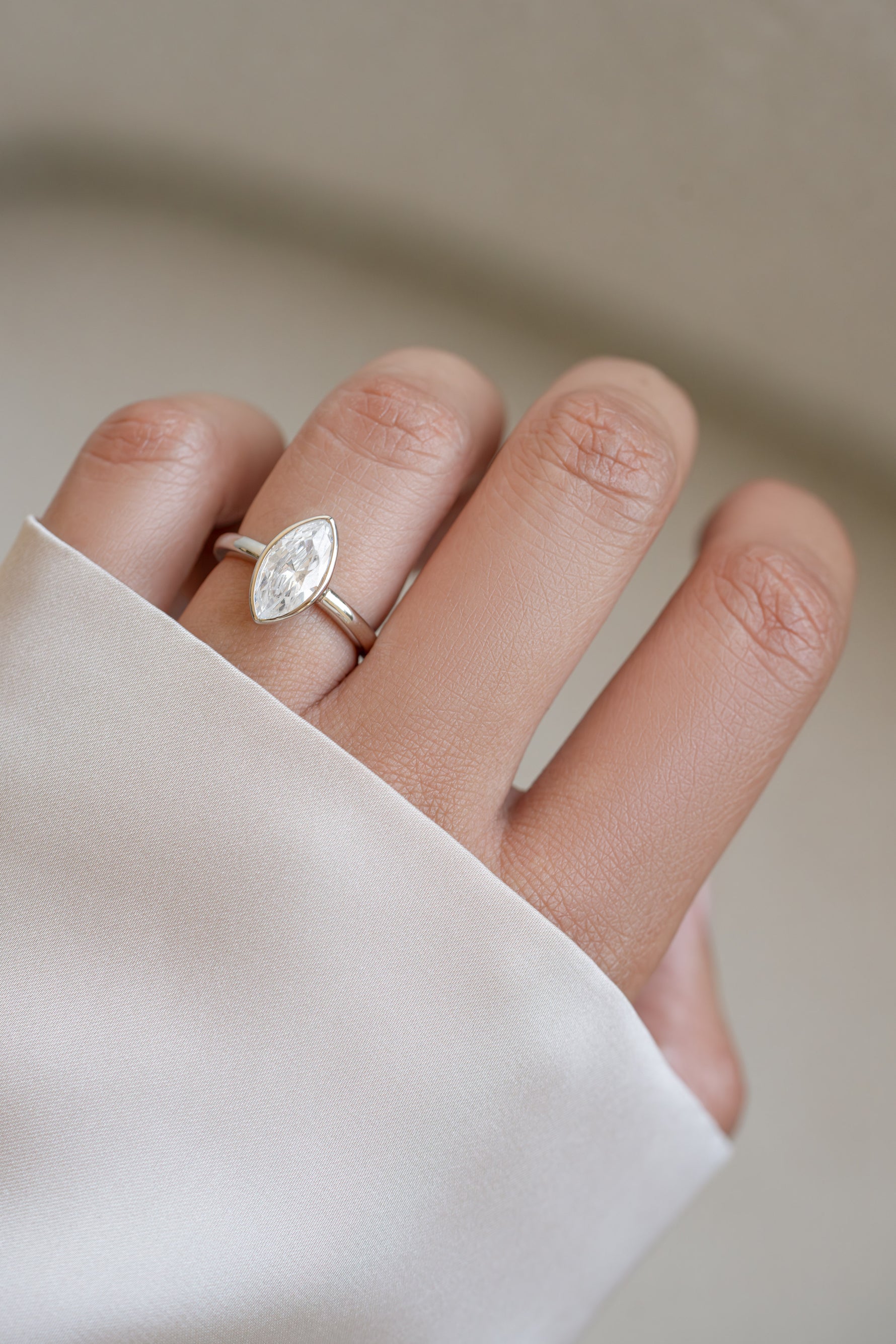 Sterling silver bezel marquise ring from Sami Jewels worn on a hand, showcasing elegant jewelry design and craftsmanship.
