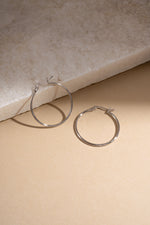 sterling silver classic hoop earrings in 30mm size neutral background