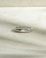 sterling silver bezeled dome ring on neutral background