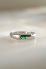 sterling silver emerald bezel set dome ring neutral background 