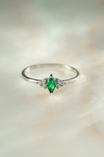 sterling silver diamond emerald marquise ring on neutral background