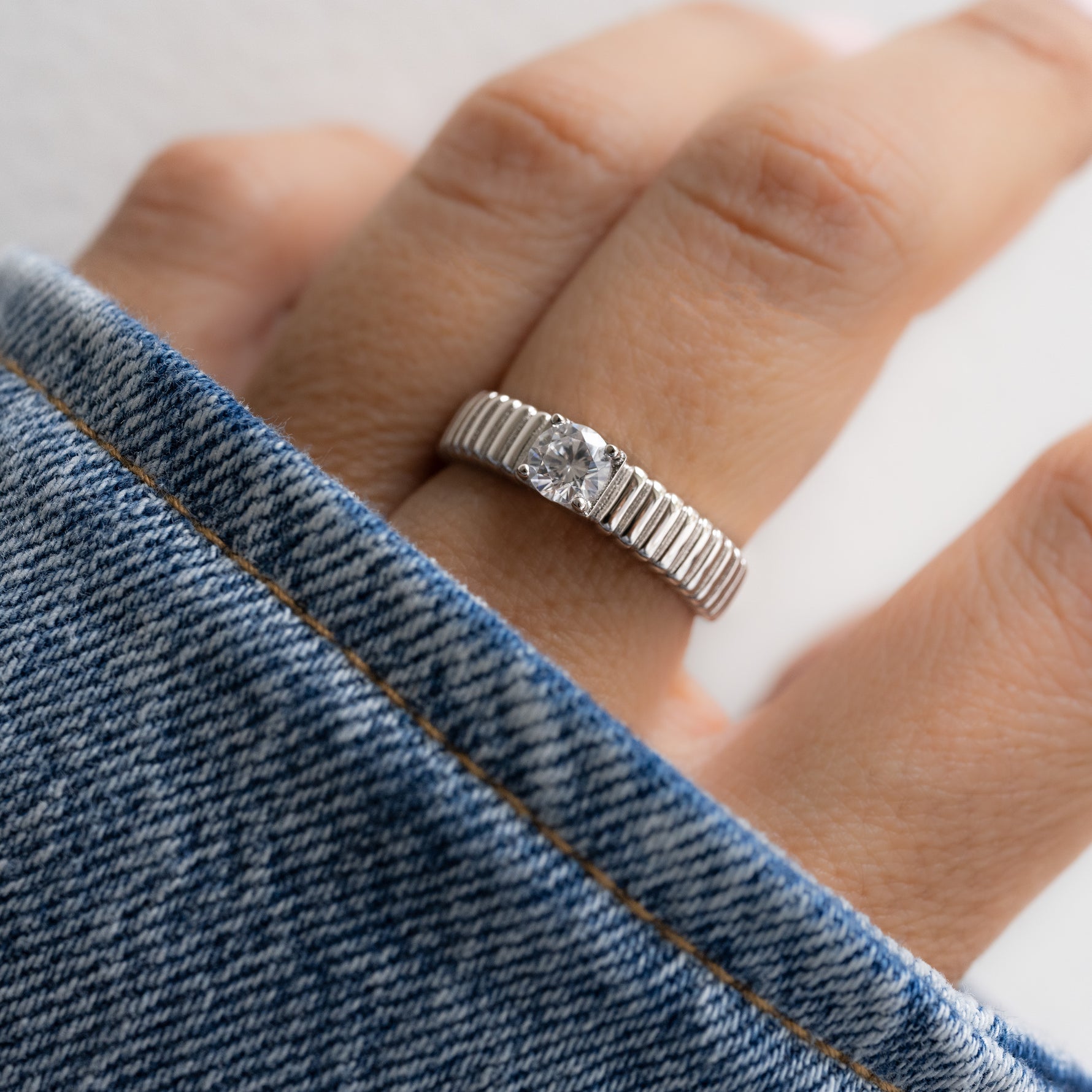 Model wearing a diamond ring with its grooves smooth yet structured, offering a velvety, rippled feel.