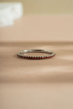 sterling silver garnet birthstone eternity ring neutral background