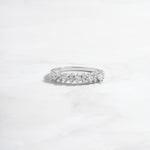 sterling silver ring with round stones made as a wedding band or stacking ring