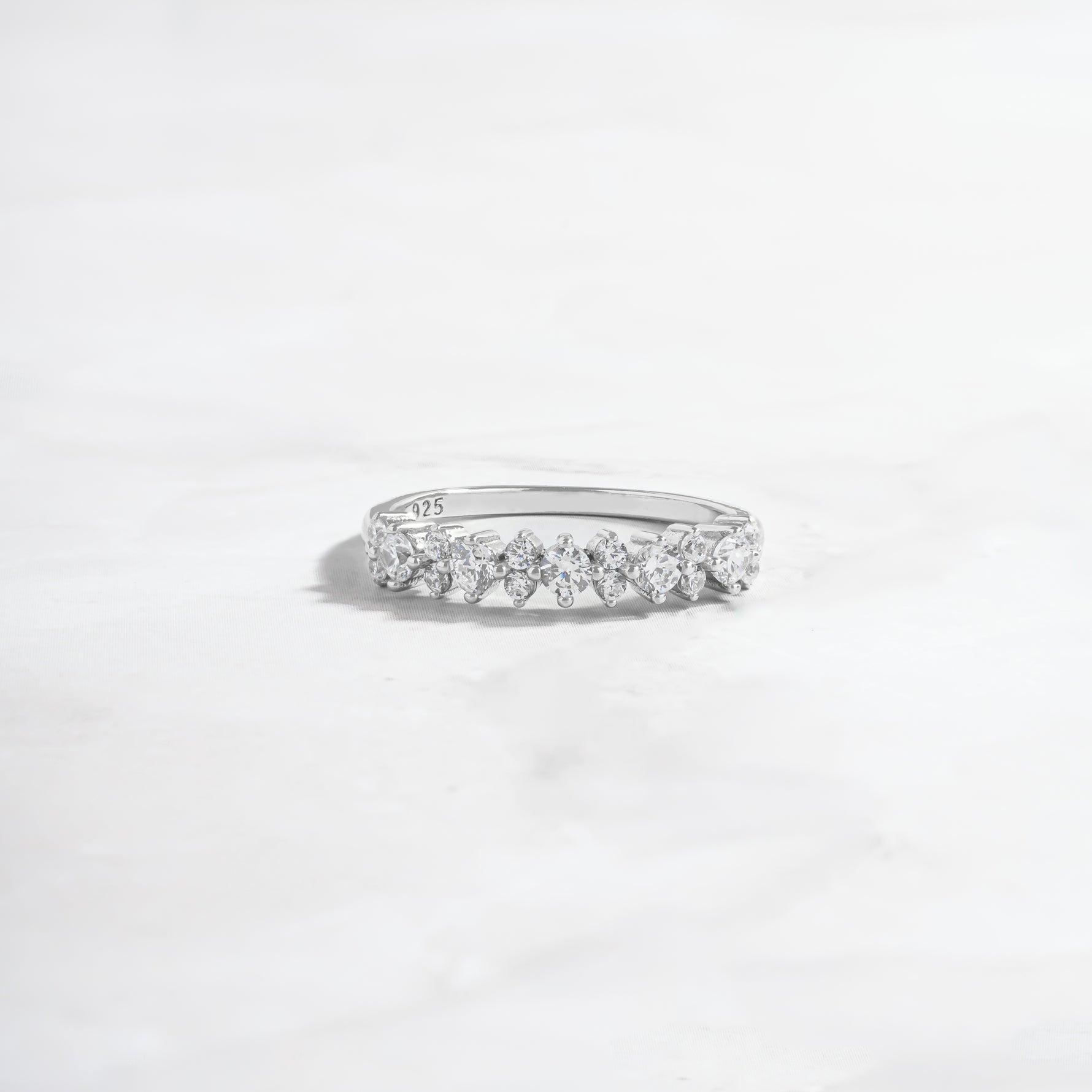 sterling silver ring with round stones made as a wedding band or stacking ring