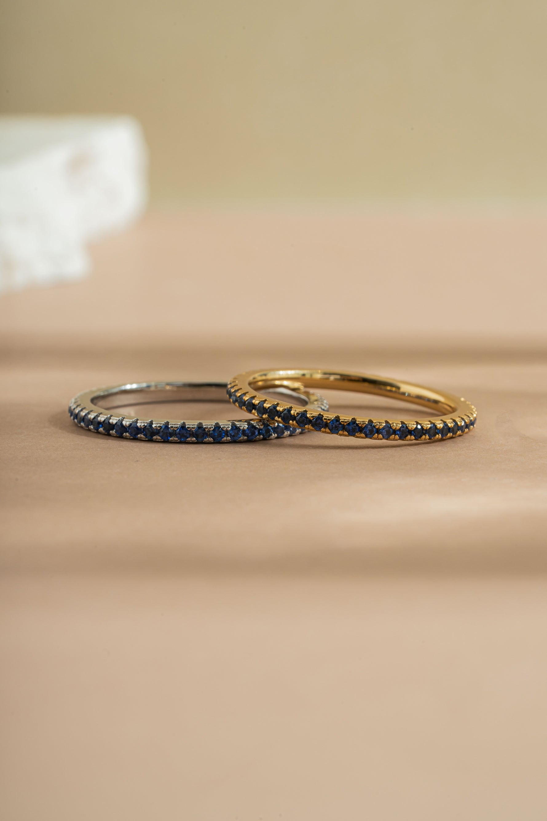 gold and sterling silver sapphire birthstone eternity ring neutral background