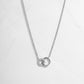 Infinity Necklace in sterling silver on white background