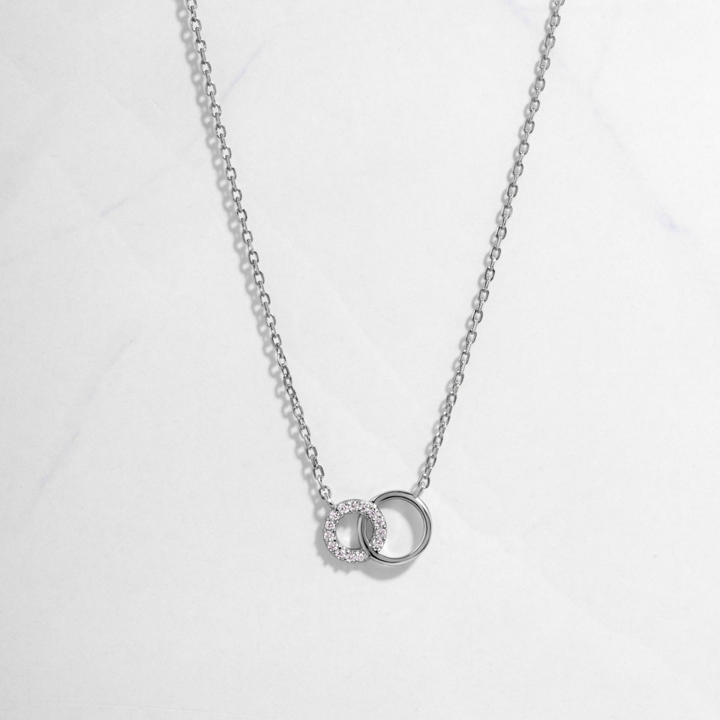 Infinity Necklace in sterling silver on white background