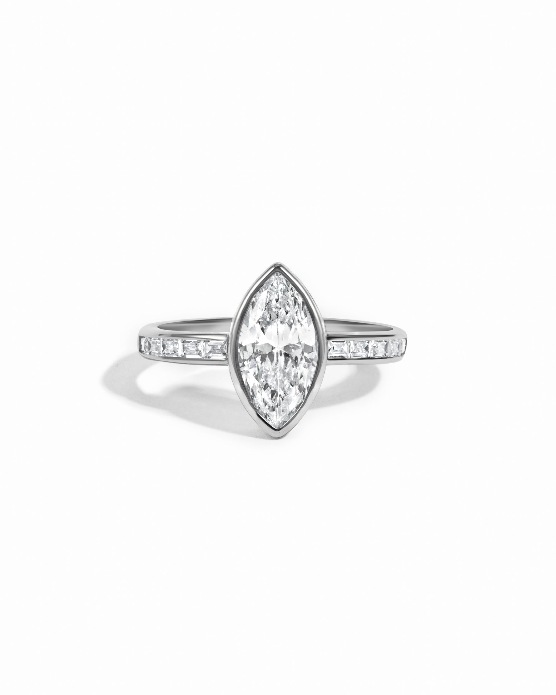 Sterling silver Bezel Marquise Ring with baguette band by Sami Jewels, featuring a marquise-shaped center stone and sleek band design.