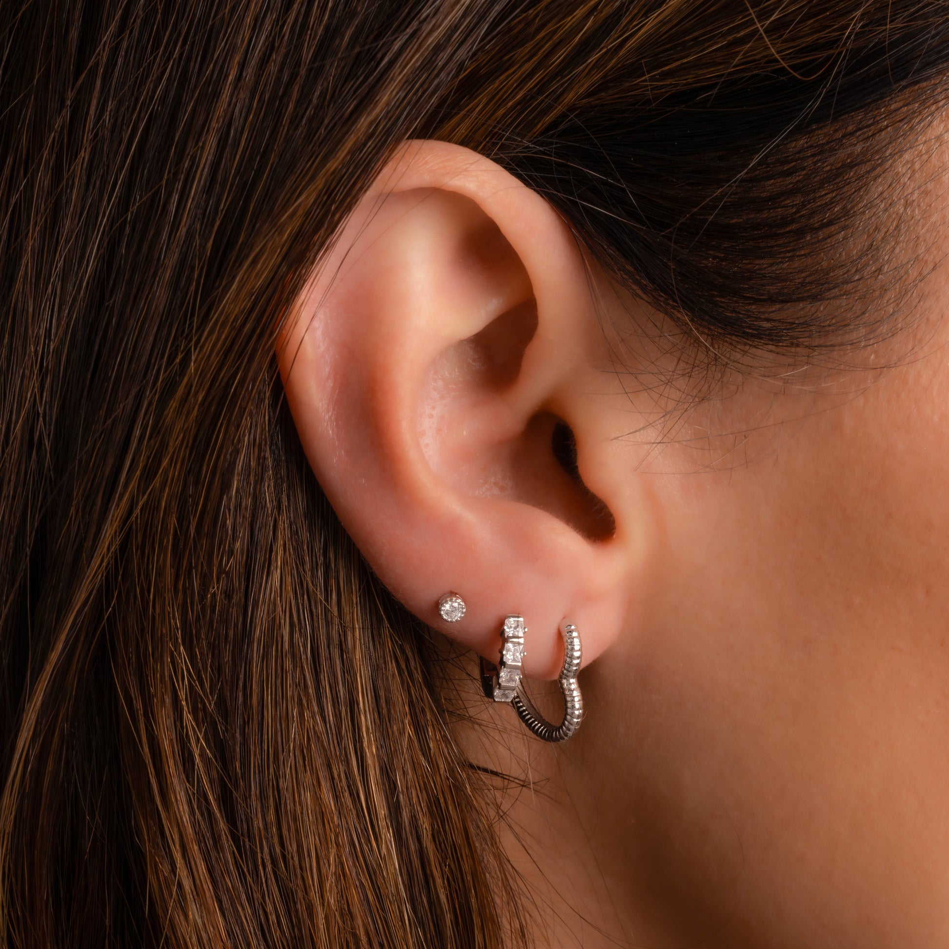 Chunky Heart Hoops in sterling silver stacked with other silver earrings