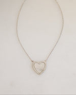 sterling silver mother of pearl heart pendant necklace on neutral surface