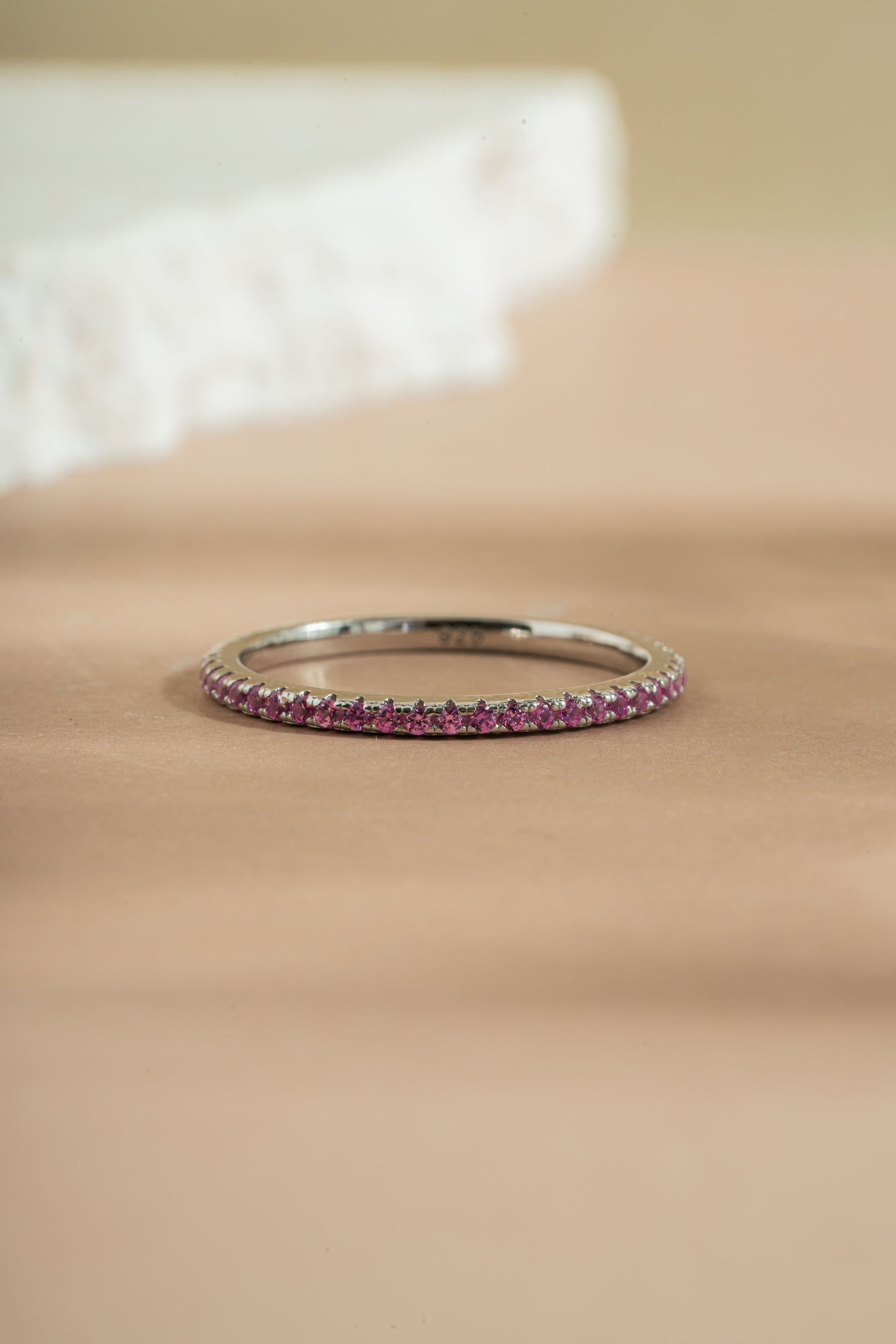 sterling silver rose October birthstone eternity ring neutral background