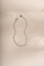a half tennis bracelet with pear cut stones