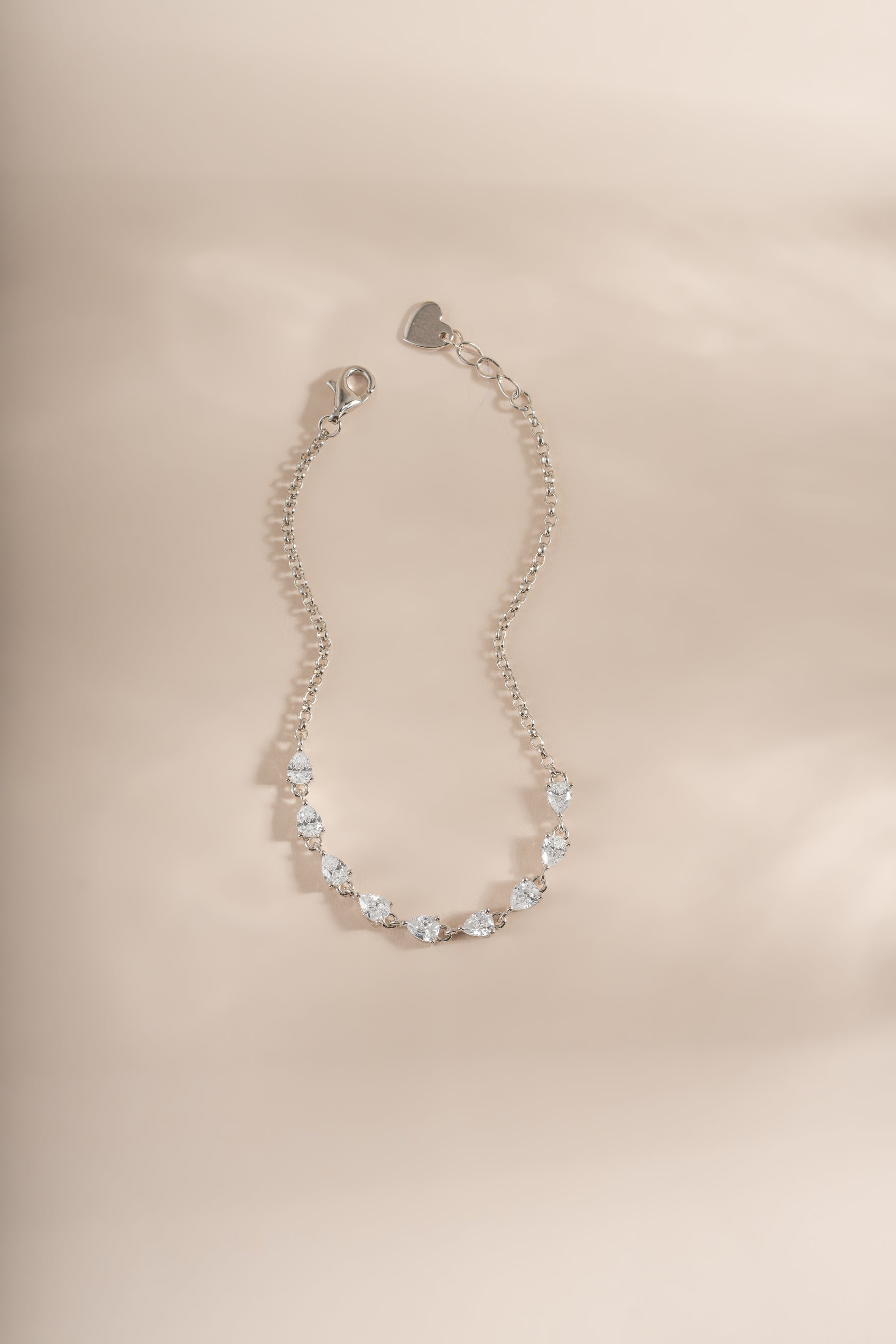 a half tennis bracelet with pear cut stones