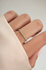 sterling silver peridot birthstone eternity ring on womens hand