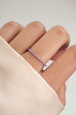 sterling silver rose October birthstone eternity ring on womens hand