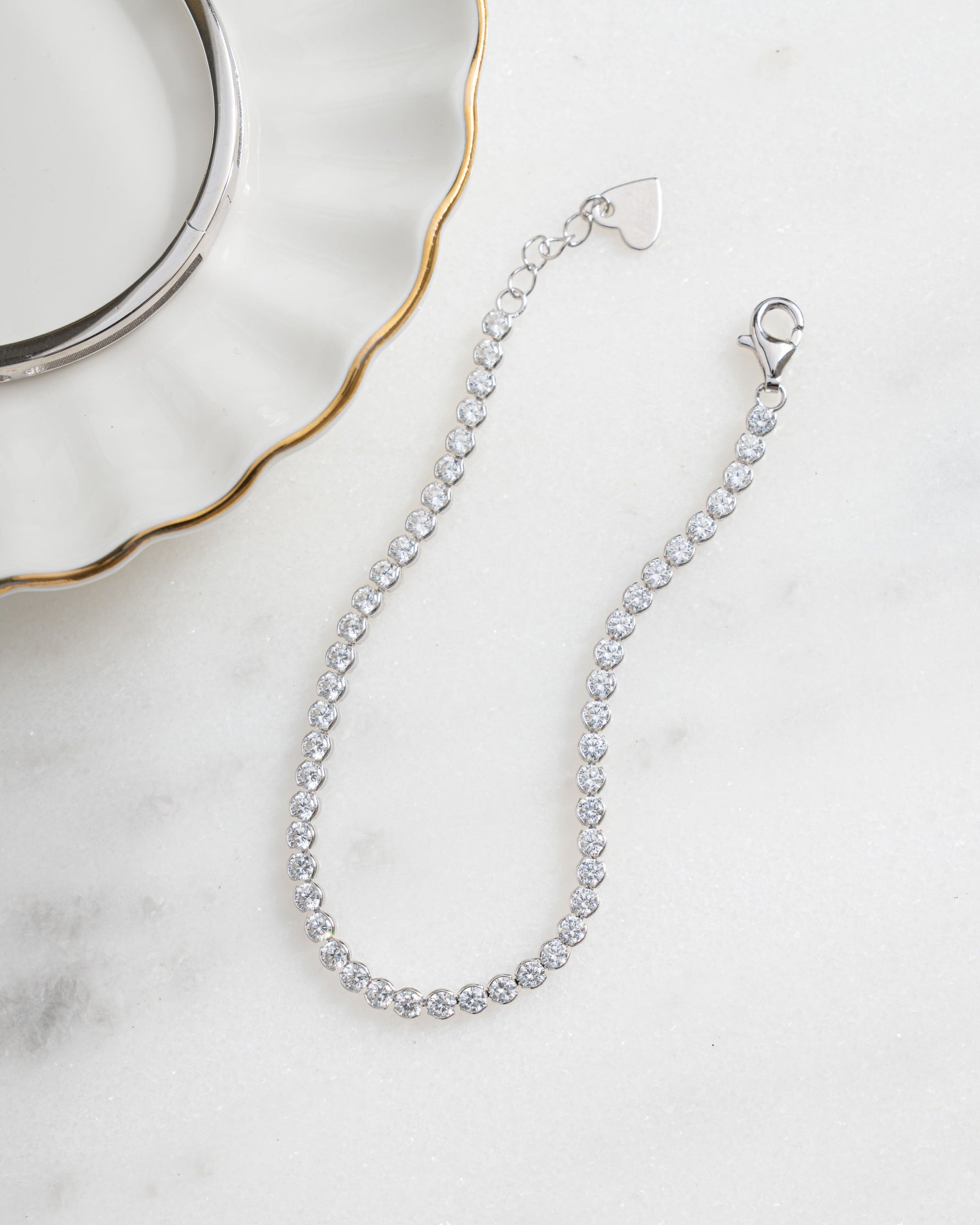 sterling silver diamond round tennis bracelet neutral background