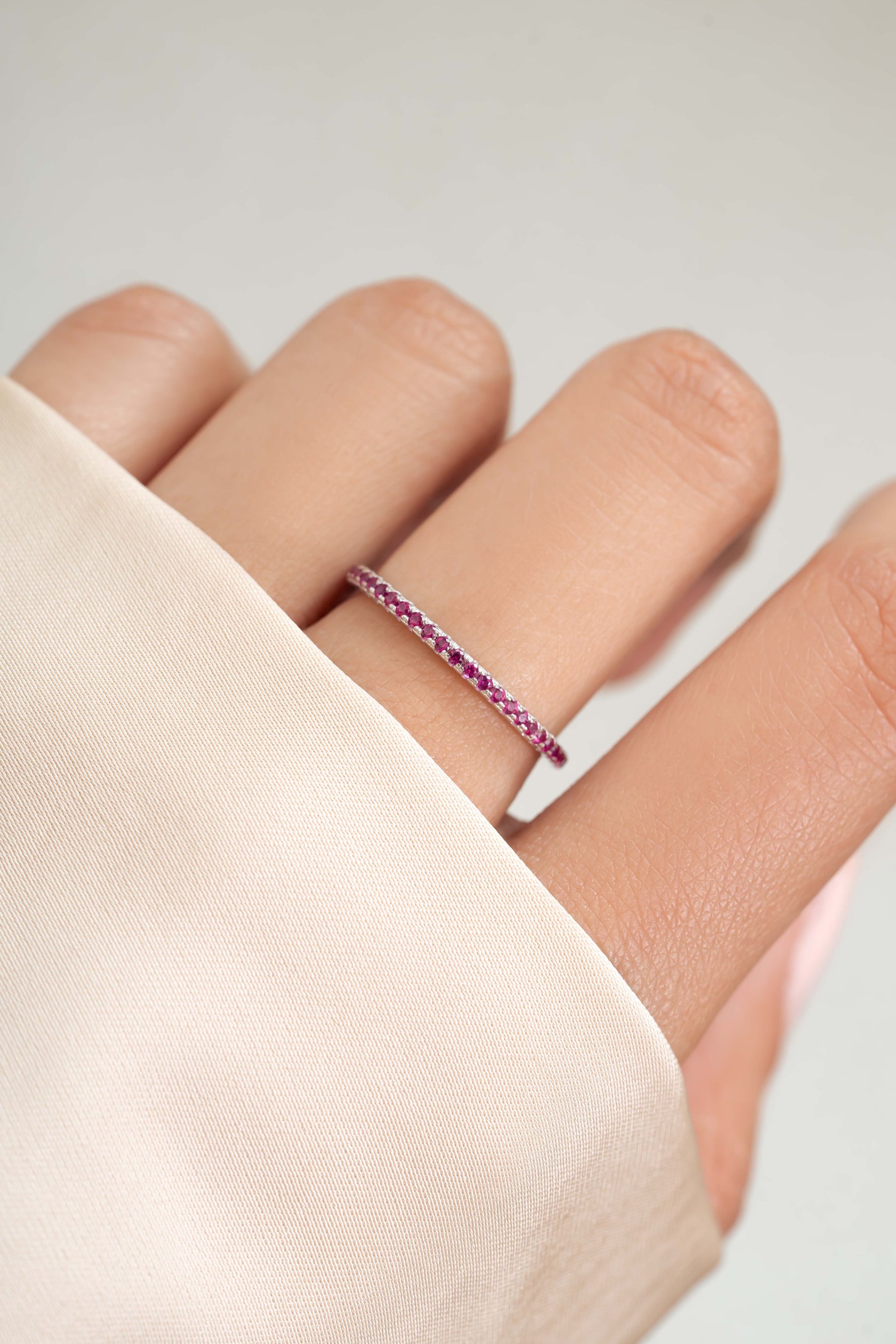 sterling silver ruby birthstone eternity ring on womens hand