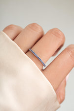 sterling silver sapphire birthstone eternity ring on womens hand