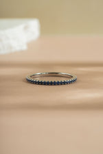sterling silver sapphire birthstone eternity ring neutral background