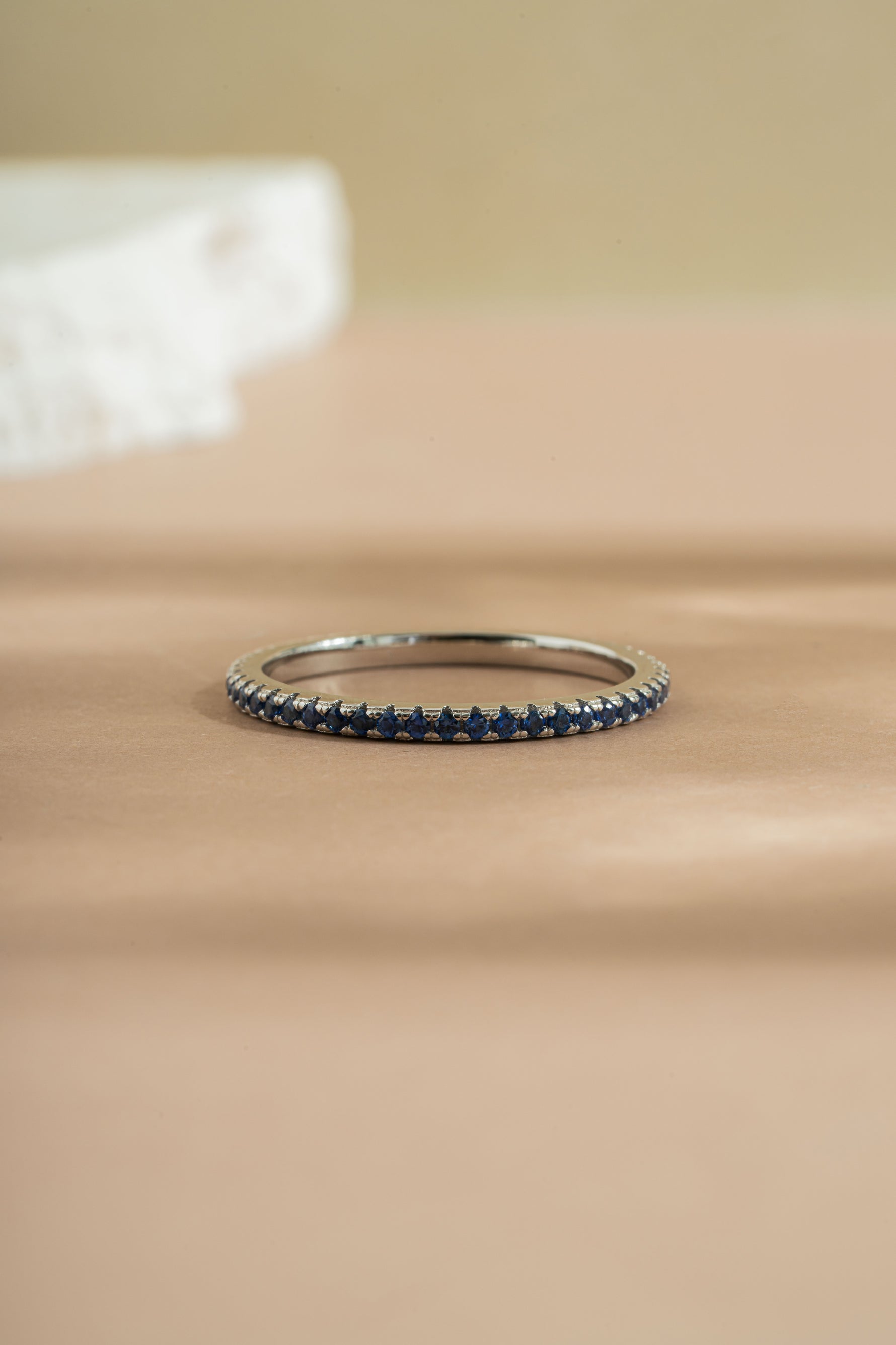 sterling silver sapphire birthstone eternity ring neutral background