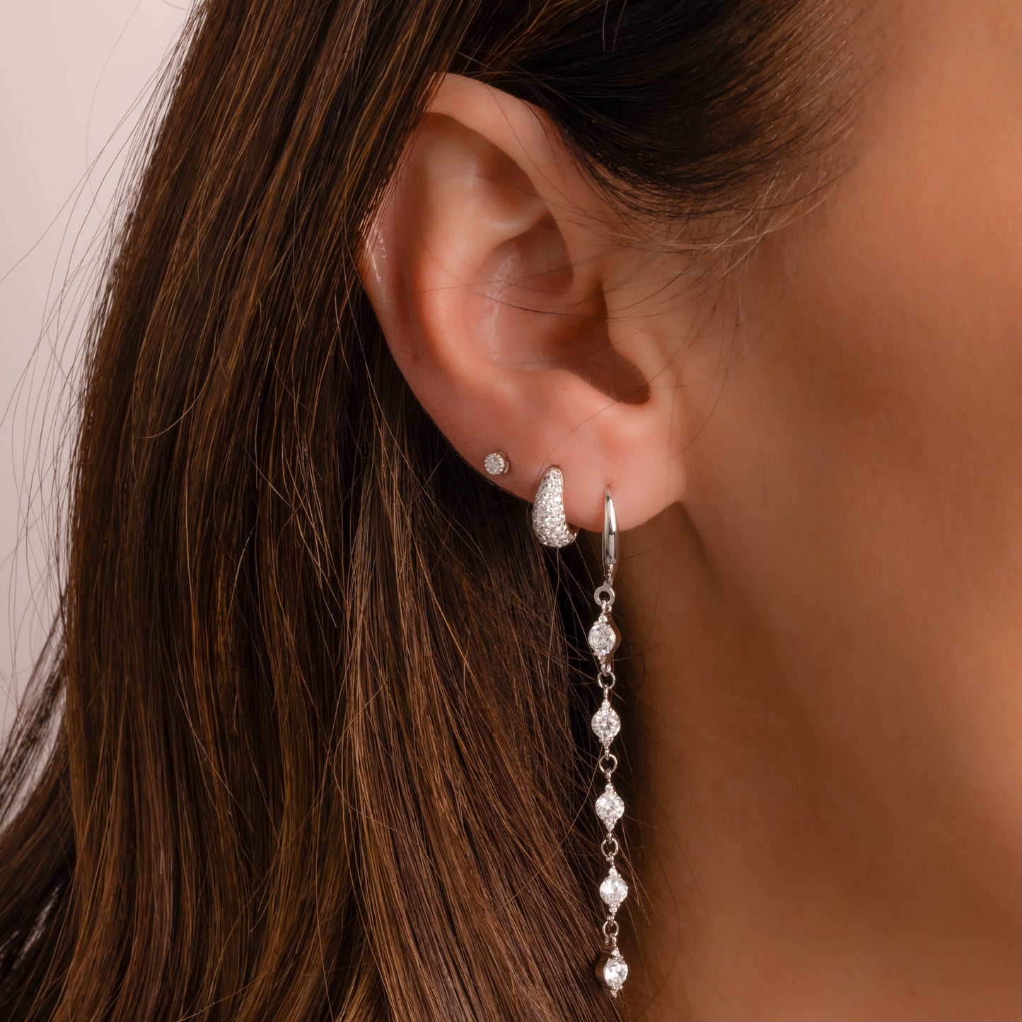 Sterling silver earrings on model, tiny diamond hoop earrings and dangle drop earrings