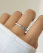 sterling silver half diamond half turquoise eternity ring on womens hand