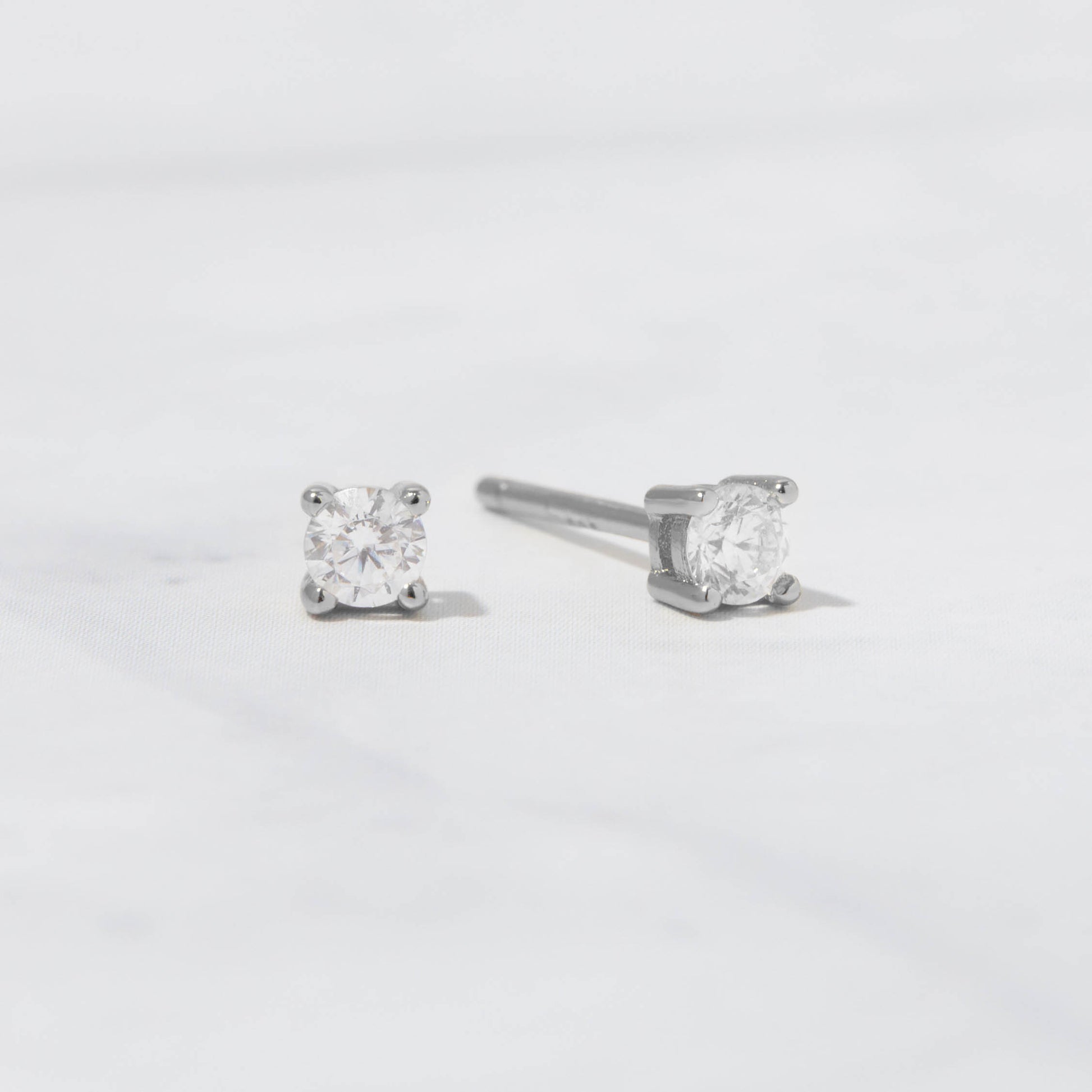 Sterling silver diamond cz stud earrings on white background