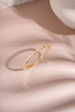 Gold Sami Jewels studded diamond bangle viewed from the top, showcasing its elegant design and sparkling embellishments.