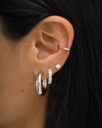 Sterling silver studded hoop earrings by Sami Jewels featuring small metal studs on classic hoop design.