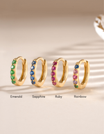 7mm emerald studded huggie earrings by Sami Jewels, gold-plated hoop earrings with vibrant emerald gemstones.