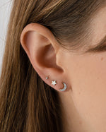 Sterling silver studded moon earrings by Sami Jewels featuring small, round studs on a crescent moon design.