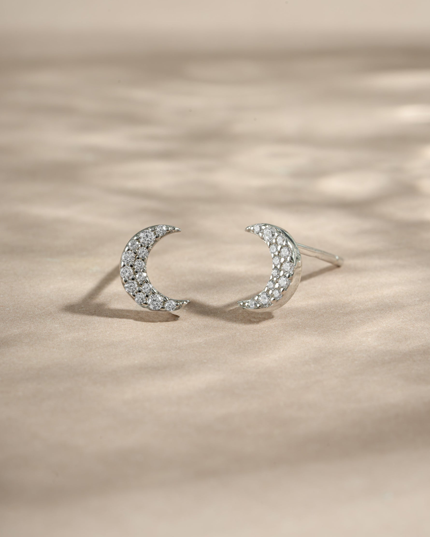 Sterling silver studded moon earrings by Sami Jewels featuring small, detailed moon designs with embedded studs.
