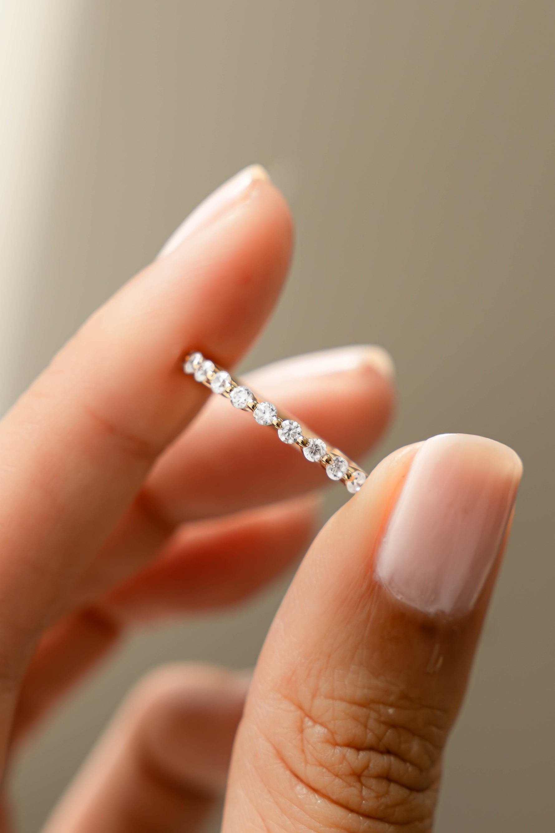 Close-up of Sami Jewels gold studded stacking ring with diamond accents, showcasing its detailed design and textured surface.