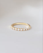 Gold Sami Jewels studded stacking ring with diamond accents, featuring multiple thin bands layered together.