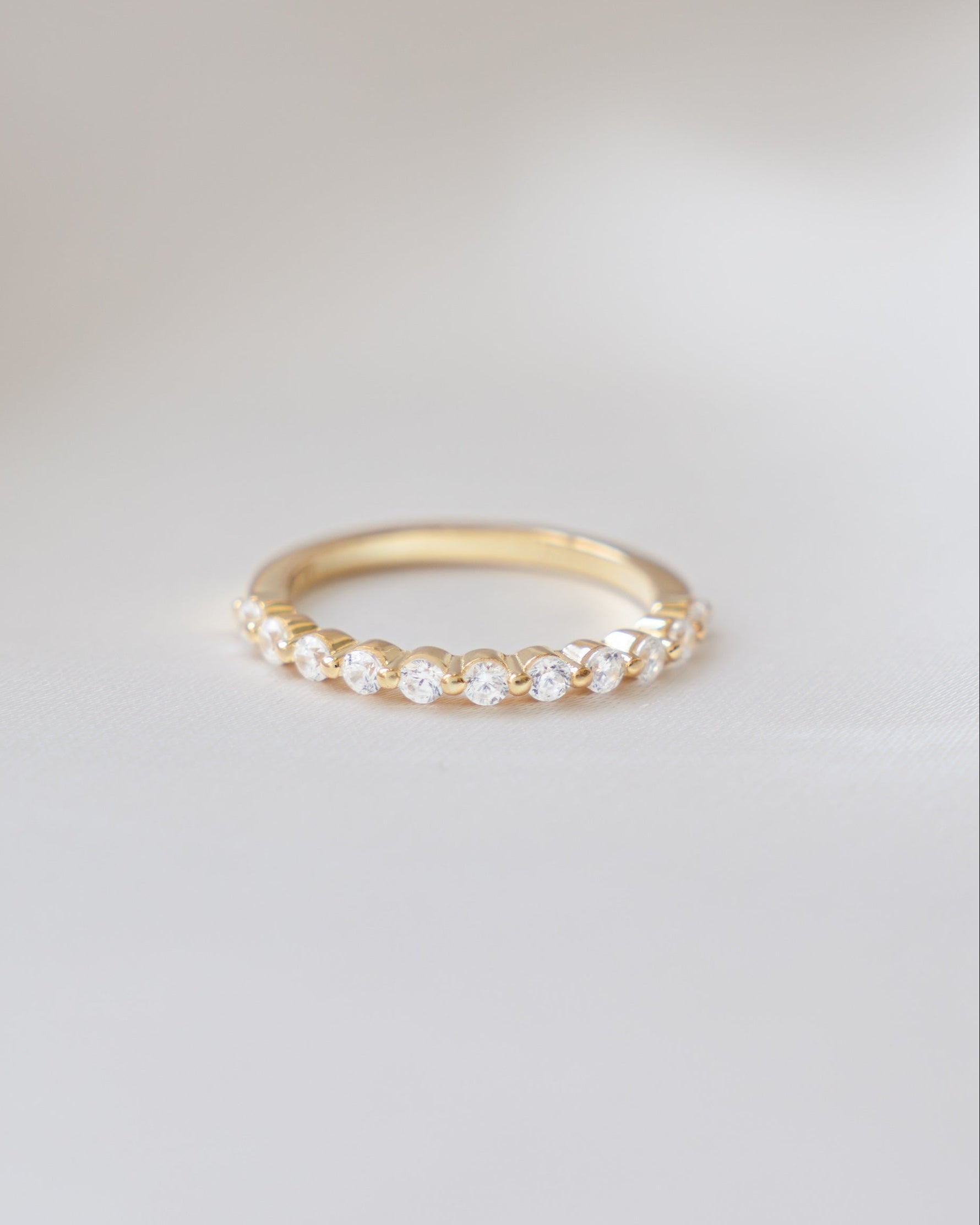 Gold Sami Jewels studded stacking ring with diamond accents, featuring multiple thin bands layered together.