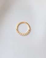 Gold studded stacking ring from Sami Jewels, featuring small diamond accents, viewed from the top showing its detailed design.