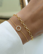 sunburst charm bracelet stack in gold on models wrist 