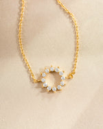 sunburst charm bracelet in gold closeup stone detail