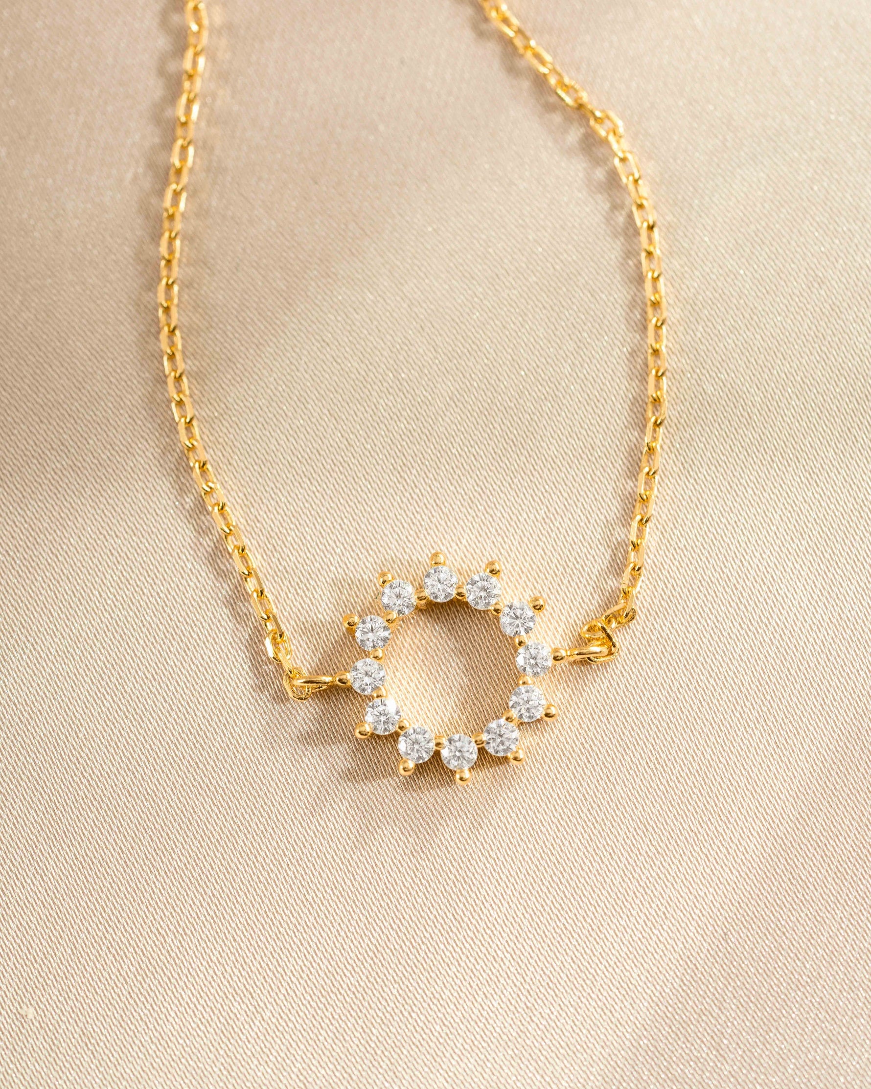 sunburst charm bracelet in gold closeup stone detail